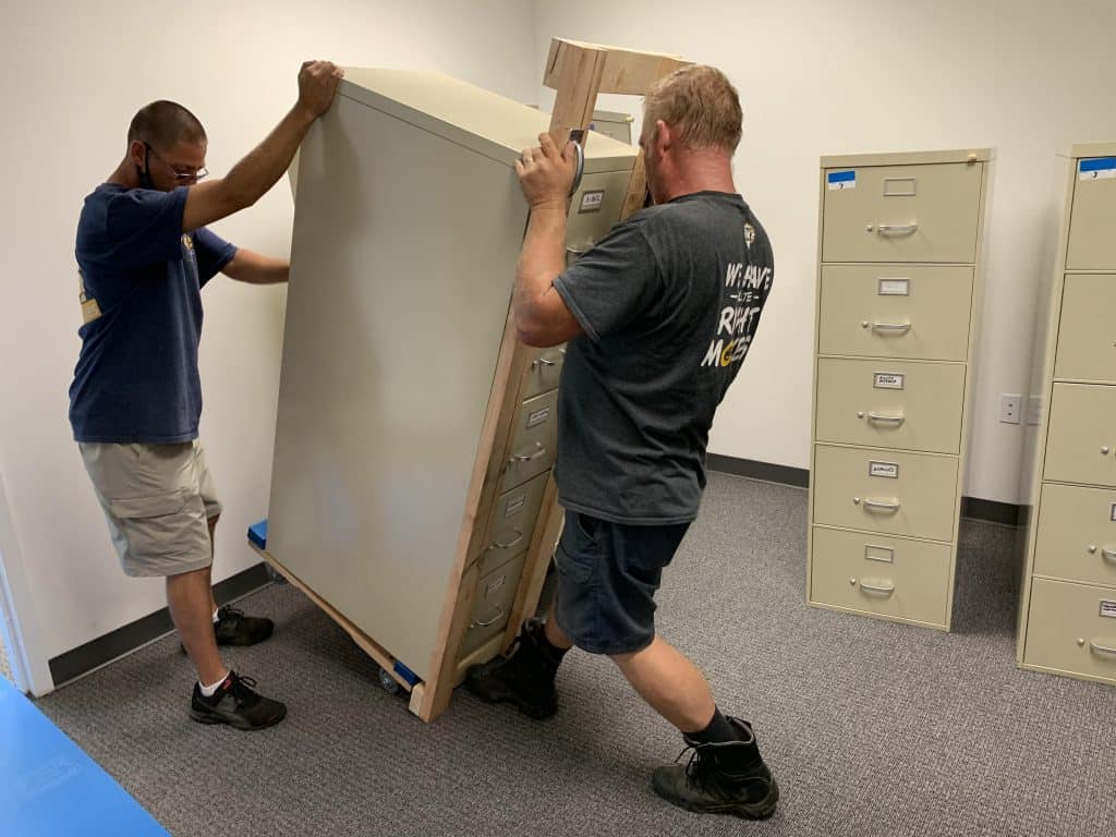 Two of our movers handling large office items. 